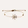 Pulsera SUNFIELD PU068491 tiene  un motivo central en forma de flor con circonitas engastadas.Se compone unas cuentas de plata chapada en 18k. de 3mm.